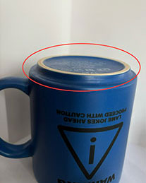 the bottom of a blue mug showing the inwards edge that fits to stack mugs on top of each other