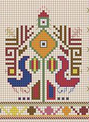 two rooster ornaments facing each other with a plant ornament in the middle